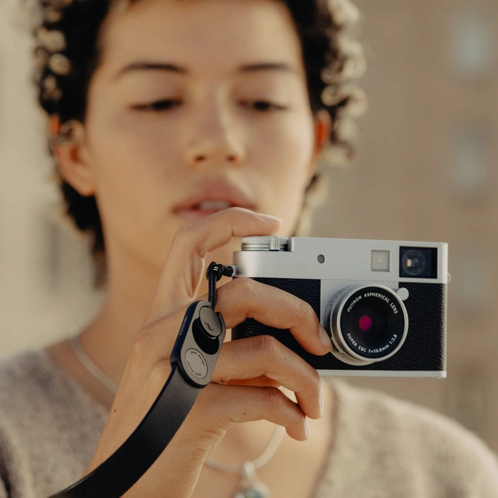 Person holding a camera with a blurred background