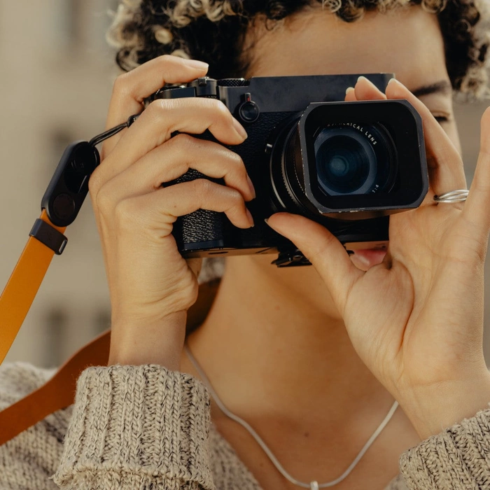 Person holding a camera with a blurred background
