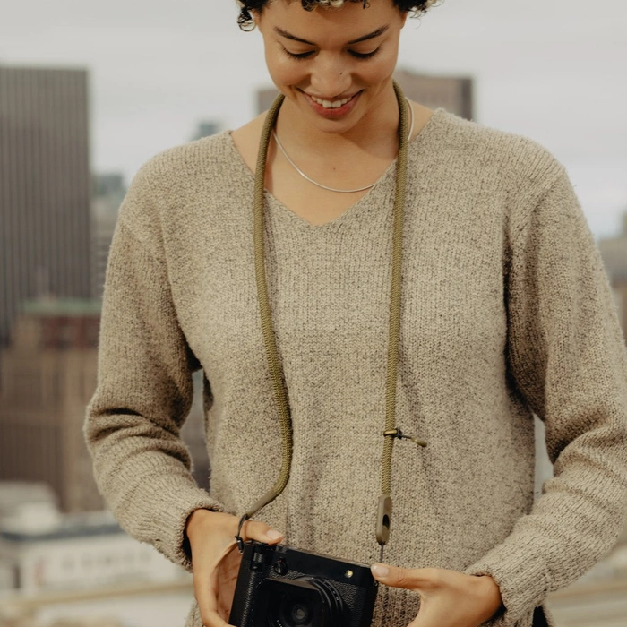 Person wearing a sweater with a Standard Kelp Rope Strap hanging around their neck