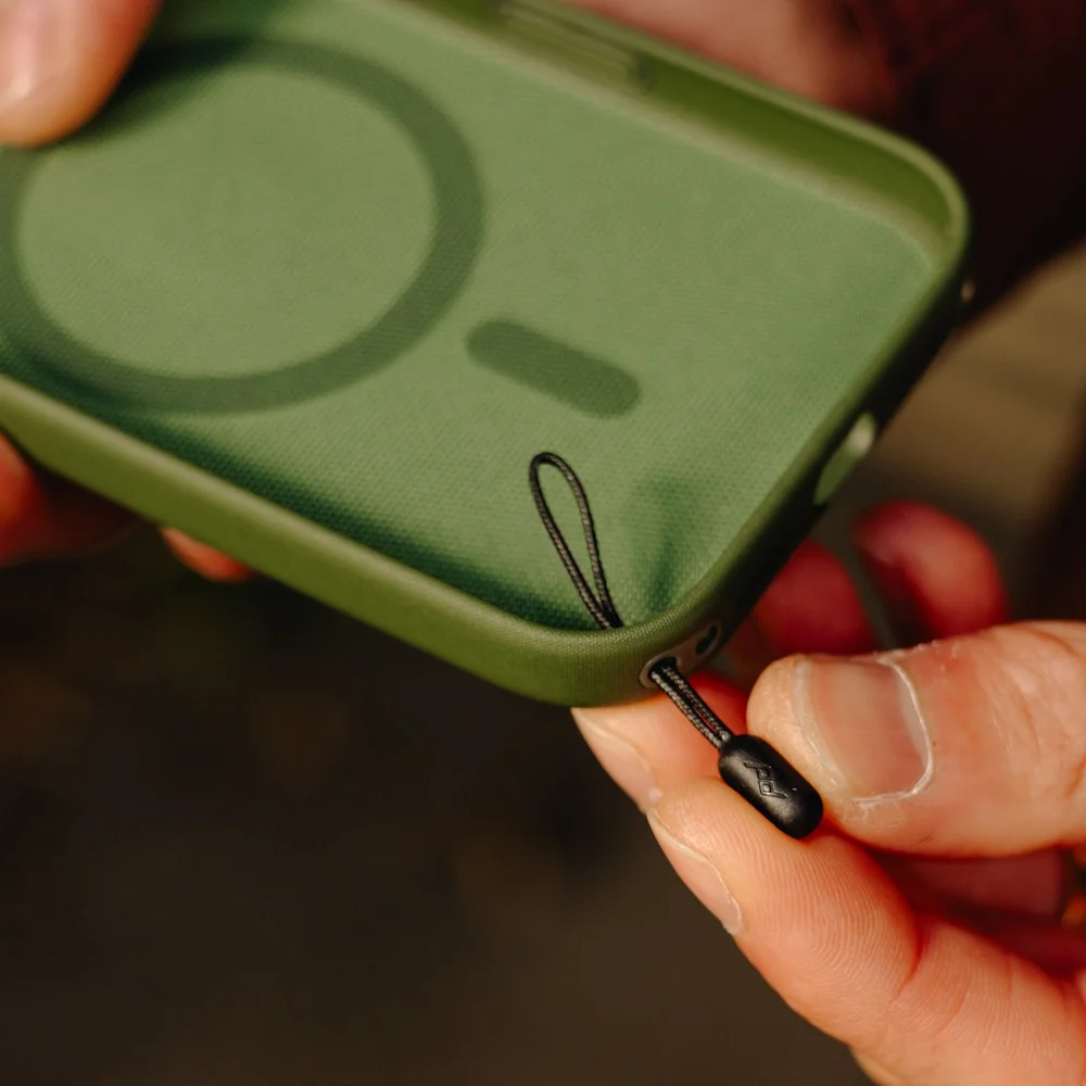 Green phone case with a Black Micro Anchor held by a person