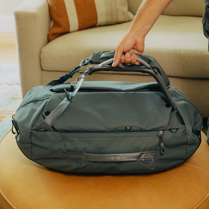Person holding the strap of Ocean Travel Duffelpack 65L